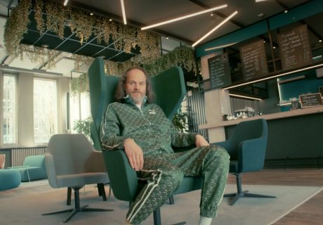 Ausstattung und Requisite Werbung "Datev", Mann mit grünem Jogginganzug sitzt in Dreh-Sessel in einer Coffeelounge